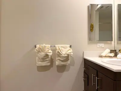 a bathroom with a sink and two towels on a towel rack at BOHO Style Home LA -Free Parking 10min To Cedars in Los Angeles