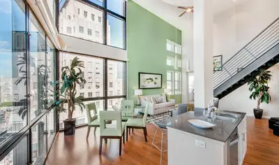 a kitchen and living room with large windows at BOHO Style Home LA -Free Parking 10min To Cedars in Los Angeles