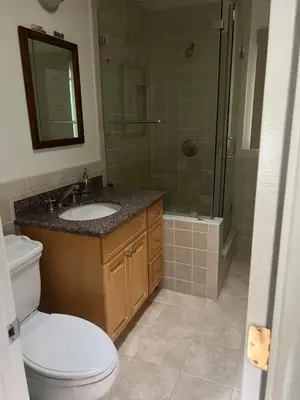 a bathroom with a toilet and a sink and a shower at Cozy Home in Picturesque LA Near Major Attractions