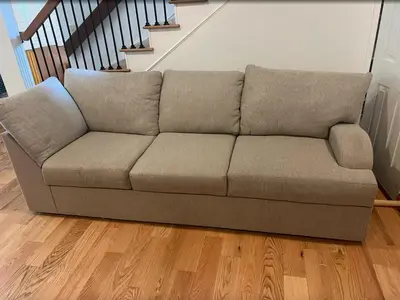 a couch in a living room with a staircase at Cozy Home in Picturesque LA Near Major Attractions