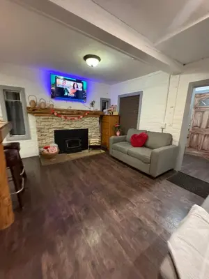 a living room with a couch and a fireplace at Snuggle Inn Cabin in Running Springs