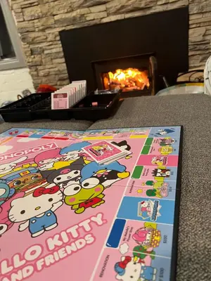 a book sitting on a table in front of a fireplace at Snuggle Inn Cabin in Running Springs