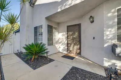 a white house with a door and some plants at Home 8 Mi to Dtwn Riverside Families Welcome! in Moreno Valley