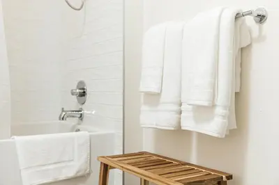 a bathroom with white towels hanging on a rack at Beautiful 1BR with City Views in Los Angeles