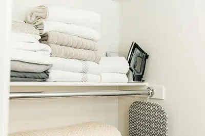 a stack of towels on shelves in a bathroom at Beautiful 1BR with City Views in Los Angeles