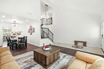 a living room with a couch and a table at Stylish Retreat Large Living Space & Bright Suites in Norwalk