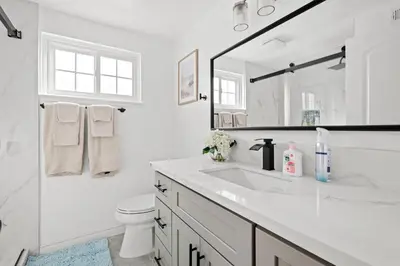 a white bathroom with a sink and a mirror at Cozy Full Suites Bright & Private Great Value in Norwalk