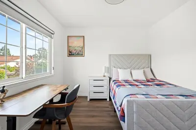 a bedroom with a bed and a desk and a table at Cozy Full Bedroom Shared Home Great Value in Norwalk