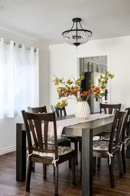 a dining room table with chairs and a vase with flowers at Cozy Full Bedroom Shared Home Great Value in Norwalk