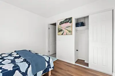a bedroom with a bed and an open door at Cozy Full Suite Private Bathroom Quiet Stay in Norwalk