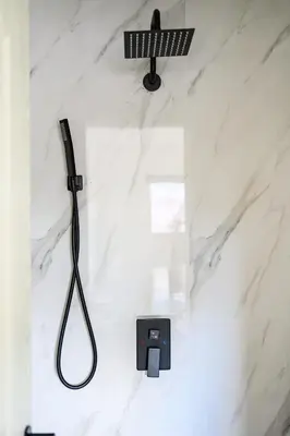 a shower in a bathroom with a black shower head at Cozy Full Suite Private Bathroom Quiet Stay in Norwalk