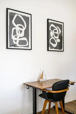 a desk with a chair and two pictures on the wall at Upgraded Queen Suite Private Ensuite Bright Stay in Norwalk