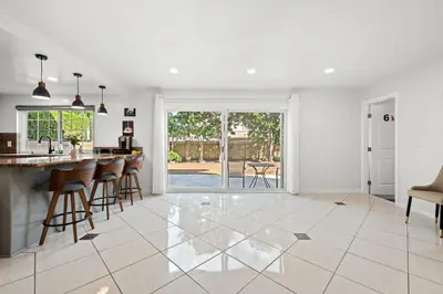 a kitchen and living room with a bar and chairs at Premium Queen Room Private Ensuite Bright in Norwalk