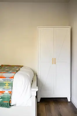 a bedroom with a white cabinet next to a bed at Premium Queen Room Private Ensuite Bright in Norwalk