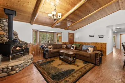 a living room with a couch and a fireplace at Leaf & Needle - Walk to Lake & Village, Picnic Table, Single Story, Fenced Yard in Big Bear Lake
