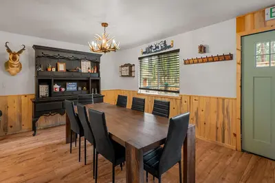 a dining room with a wooden table and chairs at The Hideaway - Near Lake & Village, Hot Tub, Fireplace, AC in Big Bear Lake