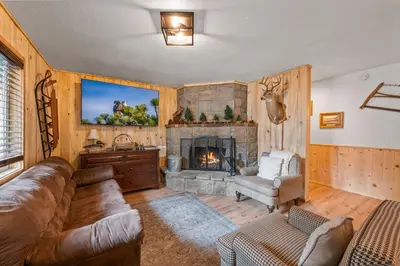 a living room with a couch and a fireplace at The Hideaway - Near Lake & Village, Hot Tub, Fireplace, AC in Big Bear Lake