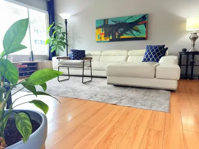 a living room with a white couch and a table at Proper Stays at Melrose - West Hollywood Modern 3-Bedroom Designer Home in Los Angeles