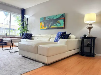 a living room with a white couch and a table at Proper Stays at Melrose - West Hollywood Modern 3-Bedroom Designer Home in Los Angeles