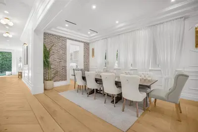 a dining room with a table and white chairs at Spaulding Ave Farmhouse in Los Angeles