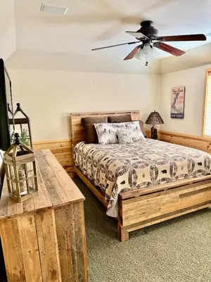 a bedroom with a bed and a ceiling fan at Winter Park Cabin Hot Tub And Game Room in Big Bear Lake