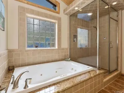 a large bathroom with a tub and a shower at Winter Park Cabin Hot Tub And Game Room in Big Bear Lake