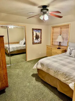 a bedroom with a bed and a ceiling fan at Winter Park Cabin Hot Tub And Game Room in Big Bear Lake