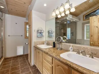 a bathroom with two sinks and a large mirror at Winter Park Cabin Hot Tub And Game Room in Big Bear Lake