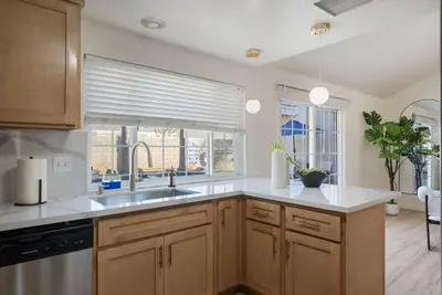 a kitchen with a sink and a window at Sunlit Oasis with Heated Pool and Jacuzzi 20 minutes to Disneyland in Placentia