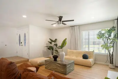 a living room with a couch and a ceiling fan at Sunlit Oasis with Heated Pool and Jacuzzi 20 minutes to Disneyland in Placentia