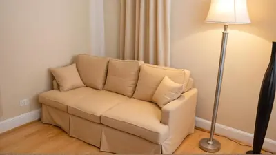 a white couch in a room with a lamp at Modern 4 & 5 BR Townhomes Minutes from Downtown LA in Los Angeles