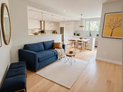 a living room with a blue couch and a kitchen at Modern 4 & 5 BR Townhomes Minutes from Downtown LA in Los Angeles