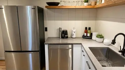 a kitchen with a stainless steel refrigerator and a sink at Modern 4 & 5 BR Townhomes Minutes from Downtown LA in Los Angeles