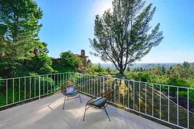 a balcony with two chairs and a view at Spacious Retreat with Scenic Mountain Views in Santa Ana