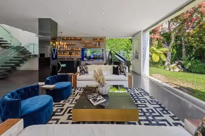 a living room with a white couch and blue chairs at Alta Royale in Los Angeles