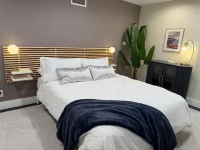 a bedroom with a large white bed and a plant at Private getaway in Studio City Hills universal in Los Angeles