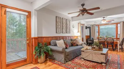 a living room with a couch and a ceiling fan at Minutes to Lake Arrowhead Village Cozy Secluded Cedar Cove by AvantStay in Lake Arrowhead