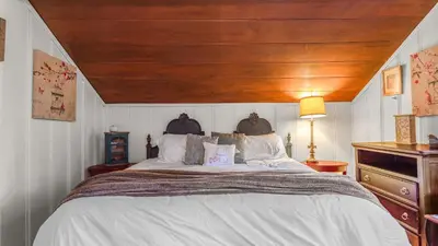 a bedroom with a large bed with a wooden ceiling at Minutes to Lake Arrowhead Village Cozy Secluded Cedar Cove by AvantStay in Lake Arrowhead