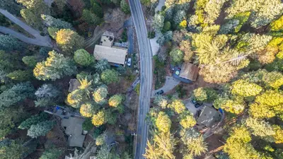 an overhead view of a road and trees at Minutes to Lake Arrowhead Village Cozy Secluded Cedar Cove by AvantStay in Lake Arrowhead