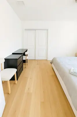 a bedroom with a bed and a desk and chairs at Relaxing time in Pasadena in Pasadena