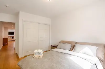 a bedroom with a large bed and a white door at Relaxing time in Pasadena in Pasadena