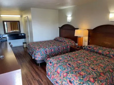 a hotel room with two beds in a room at Sierra Inn in South El Monte