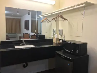 a bathroom with a sink and a microwave at Sierra Inn in South El Monte