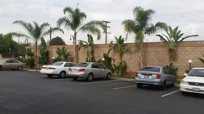 a group of cars parked in a parking lot at Sierra Inn in South El Monte