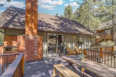 a house with a deck with a bench and a fireplace at Mountain Getaway - Stunning Views in Pine Mountain Club