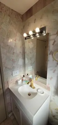 a bathroom with a sink and a mirror at The Cozy Corner in Canoga in Canoga Park