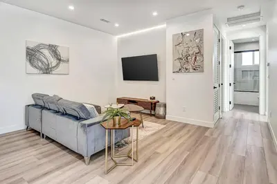 a living room with a couch and a tv at Modern 3BR with King Bed, Gated Pool and BBQ Oasis in West Valley Area Heliport