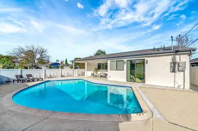 a swimming pool in the backyard of a house at Modern 3BR with King Bed, Gated Pool and BBQ Oasis in West Valley Area Heliport
