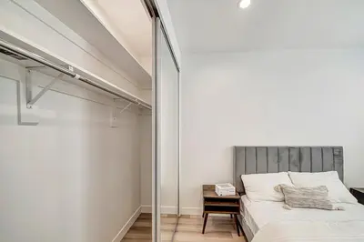 a bedroom with a bed and a glass wall at Modern 3BR with King Bed, Gated Pool and BBQ Oasis in West Valley Area Heliport