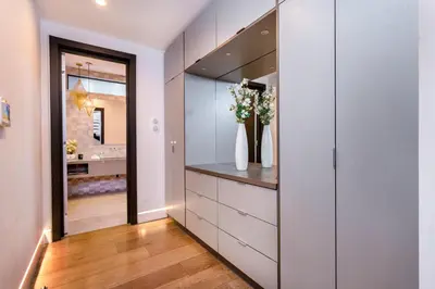 a walk in closet with a vase of flowers at Ultra Luxe Estate With Pool and Stunning 360 LA Views in Los Angeles